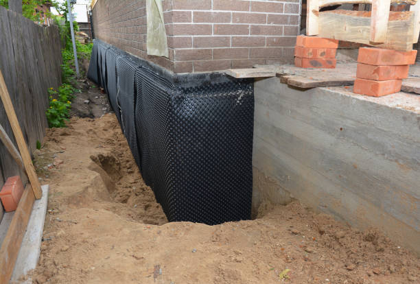 SJ Waterproofing Pros technician performing targeted Wet Basement Repair assessment in Tontogany, OH
